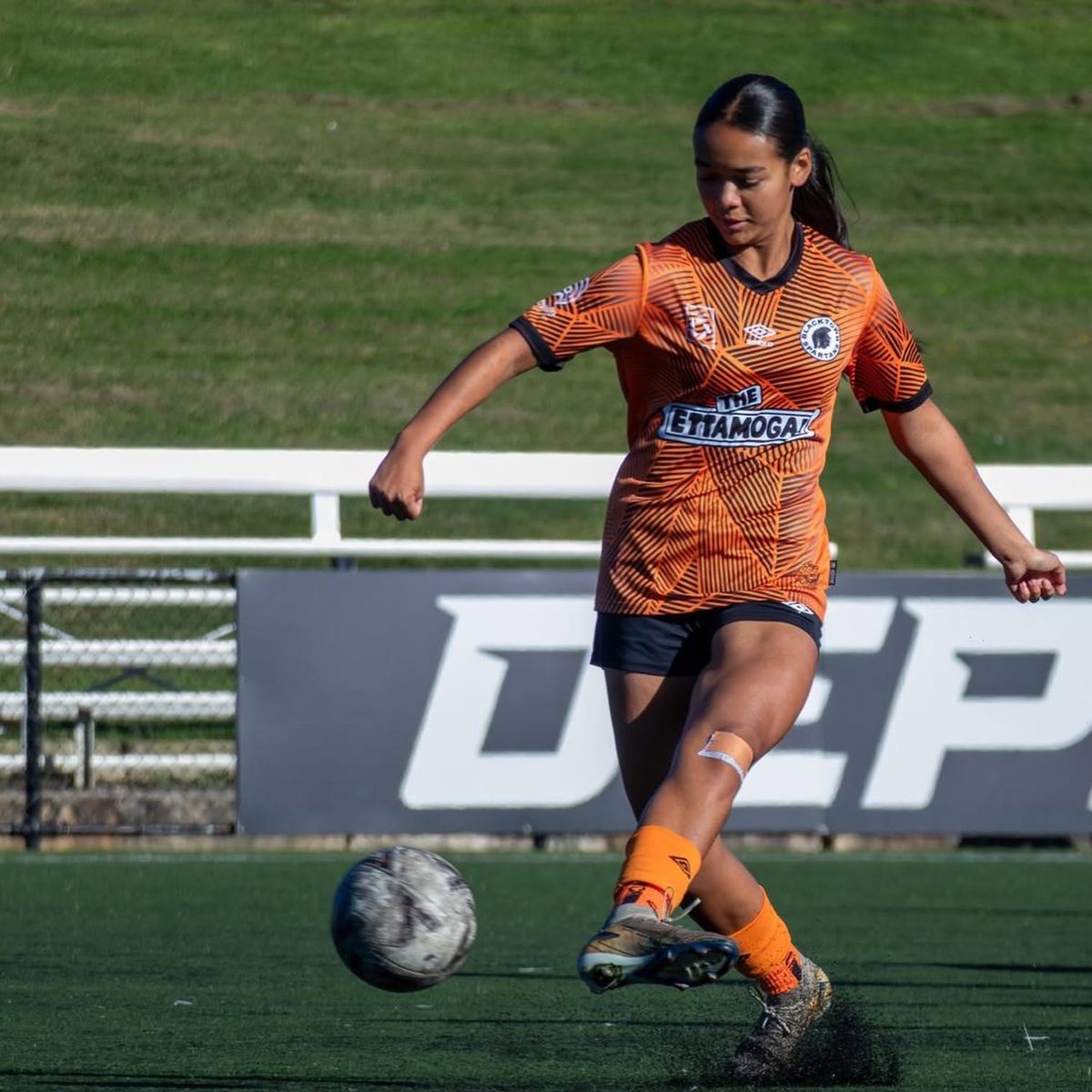 Blacktown Spartans player striking a pass at Blacktown Football Park
