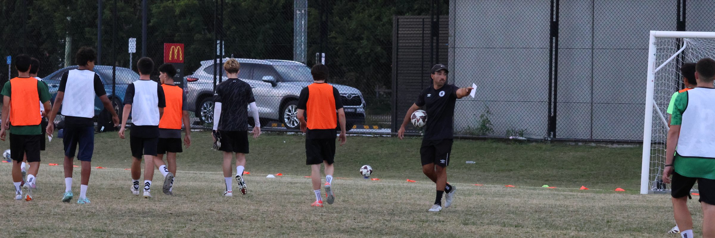 Development players heading to the next drill with their coach at training