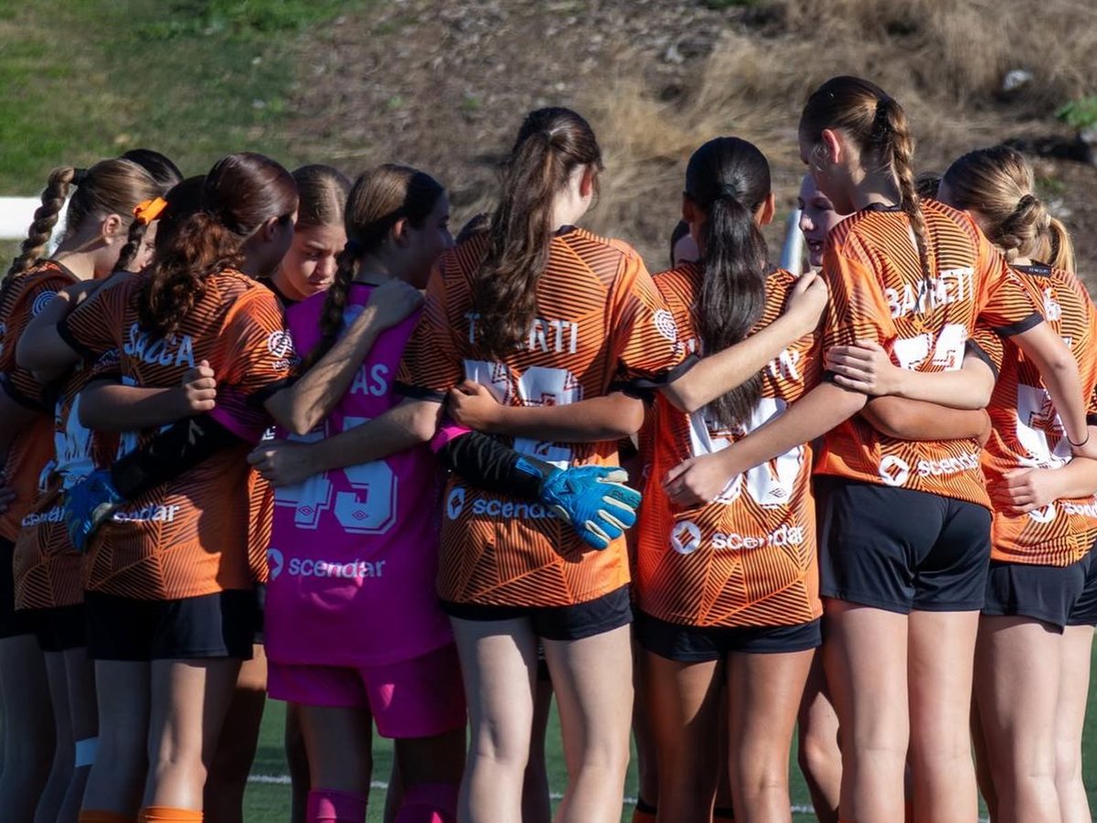Blacktown Spartans Girls' Youth League players in a team huddle
