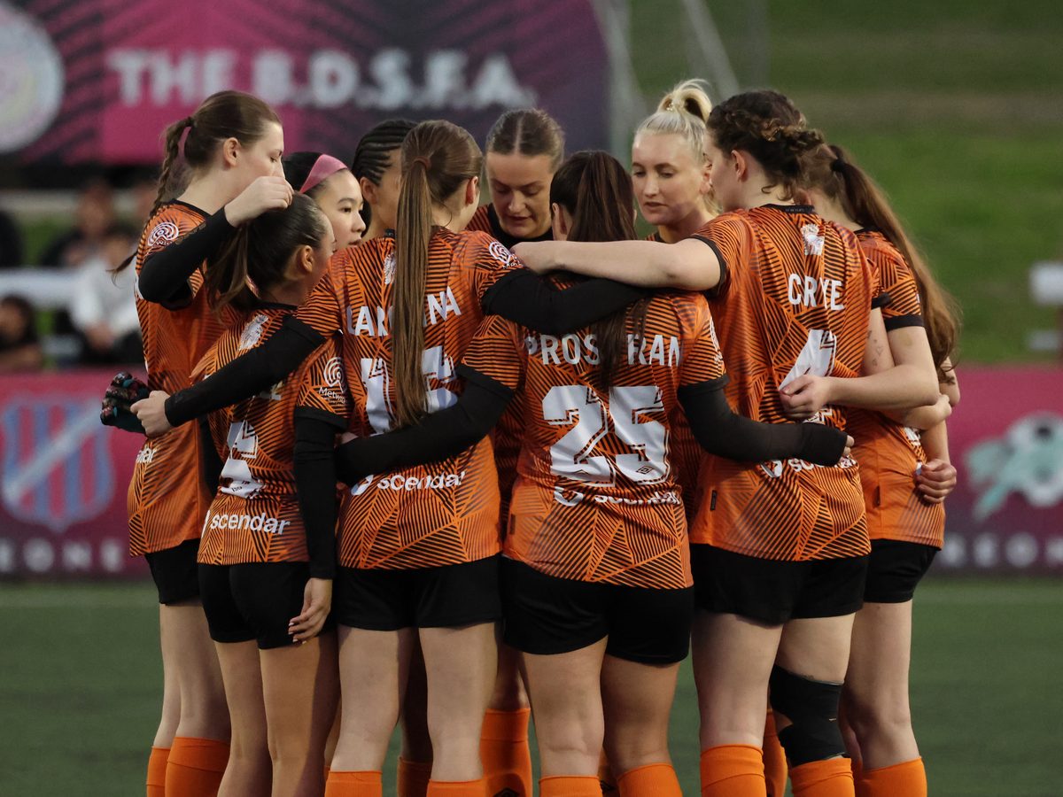 Blacktown Spartans women's first grade in a team huddle
